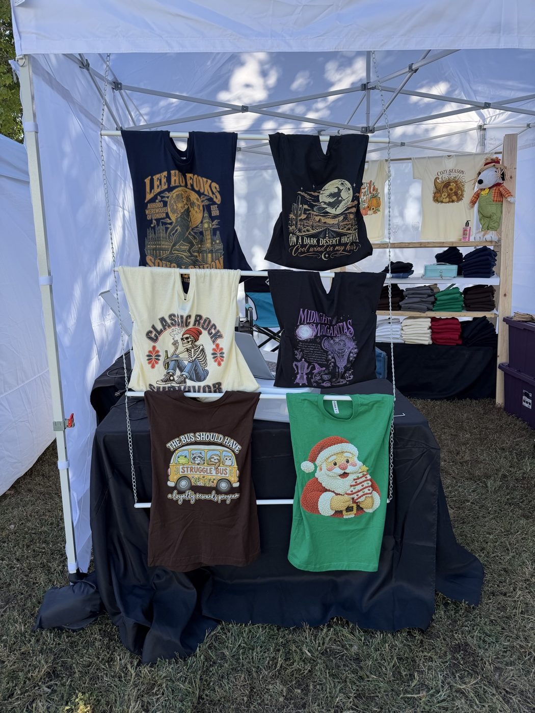Tees displayed on a stand at a vendor fair